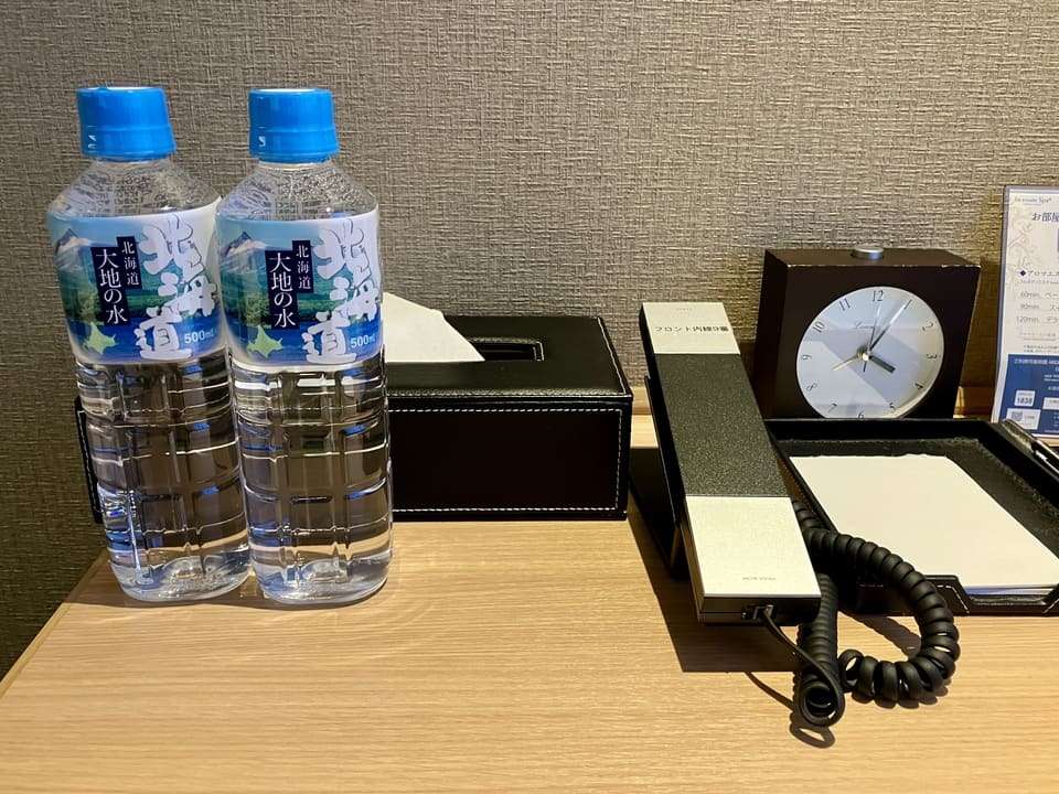 ボトルウォーターとティッシュ、電話機、真覚まし時計